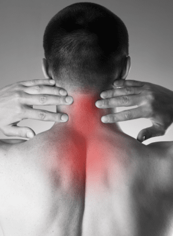 A man holds his fingertips to his inflamed spine 